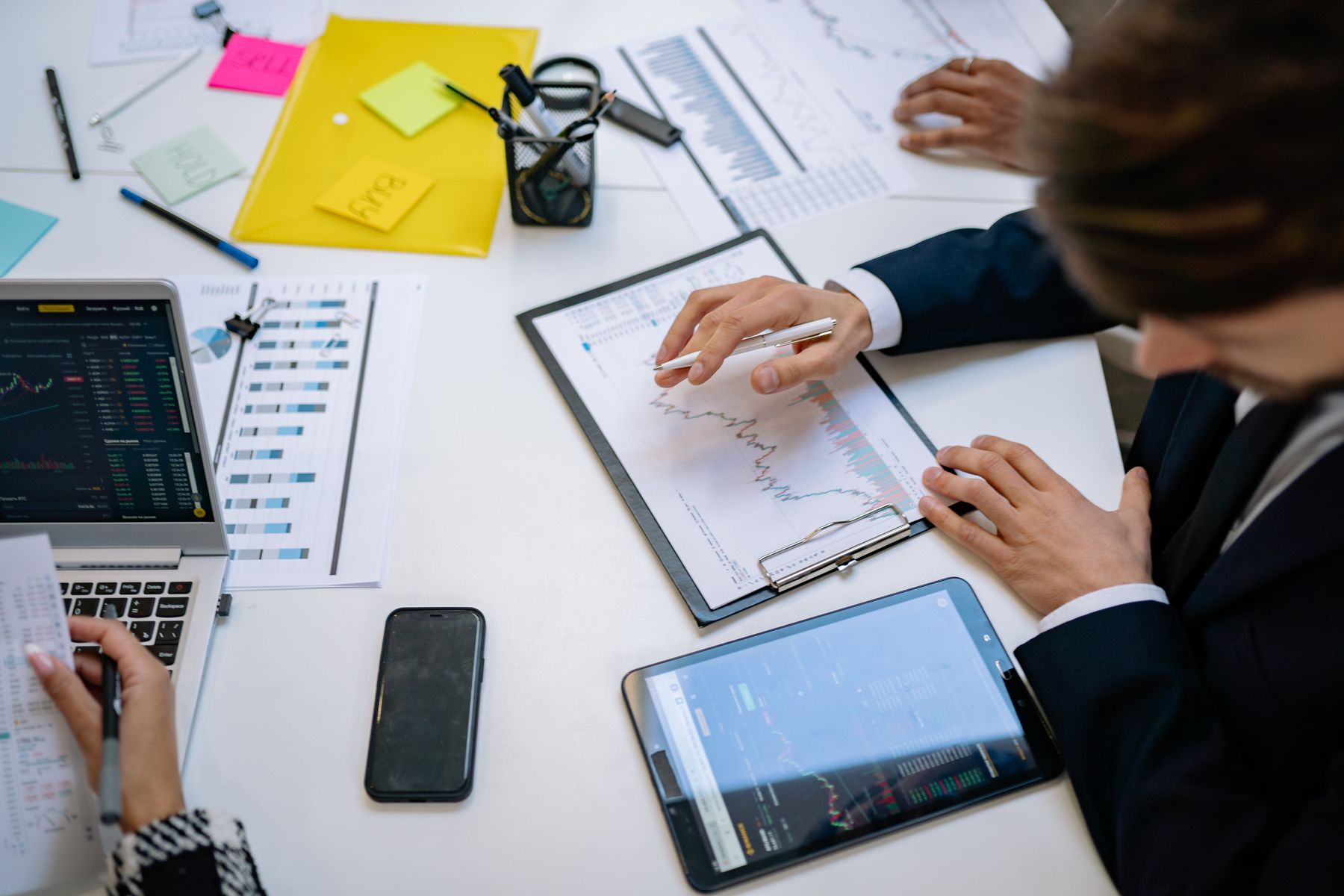 A team reviewing investment charts and financial data
